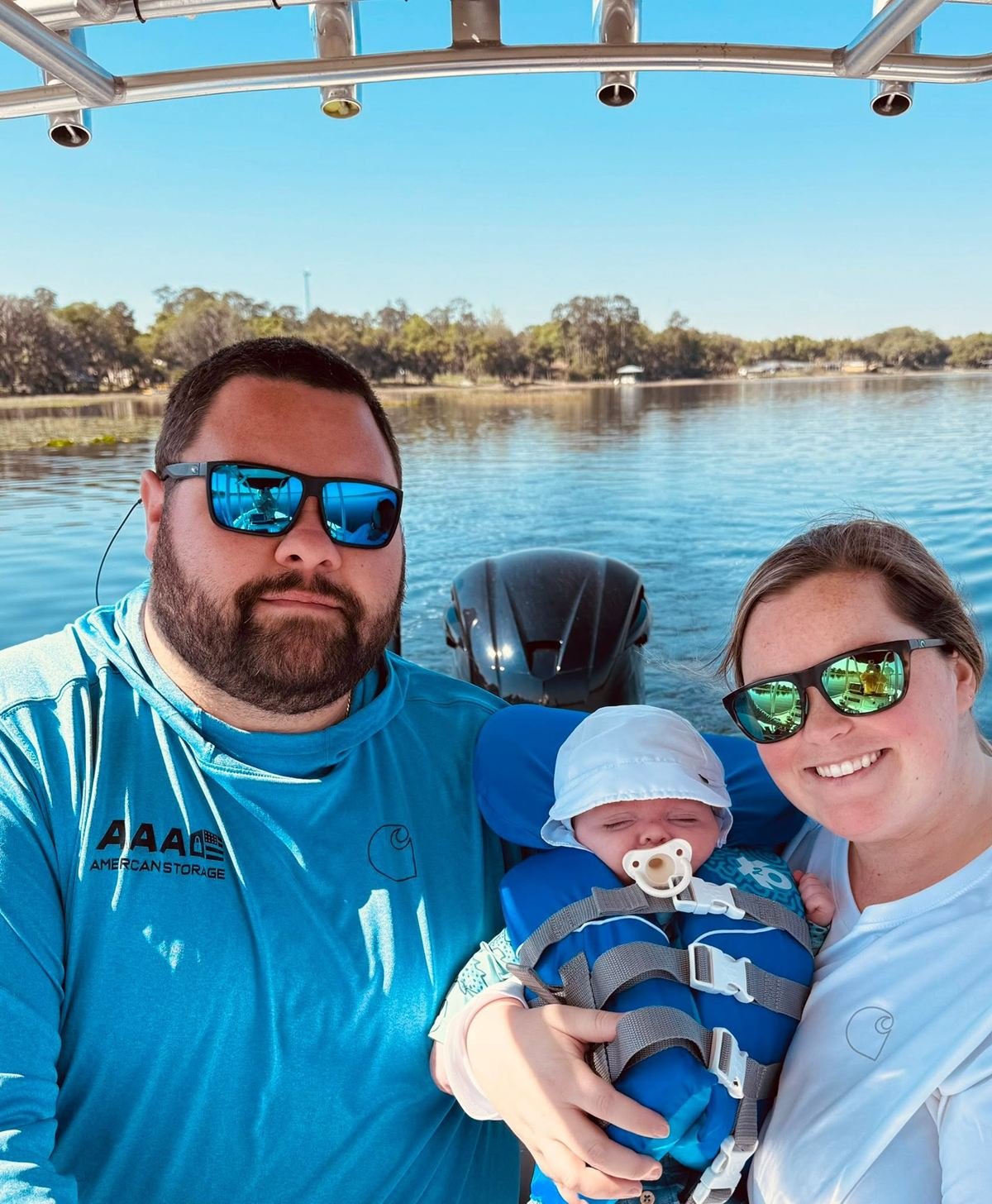 Stephen and Lauryn Hubert, founders of Blue Ridge Investment Group, with their baby out on the lake